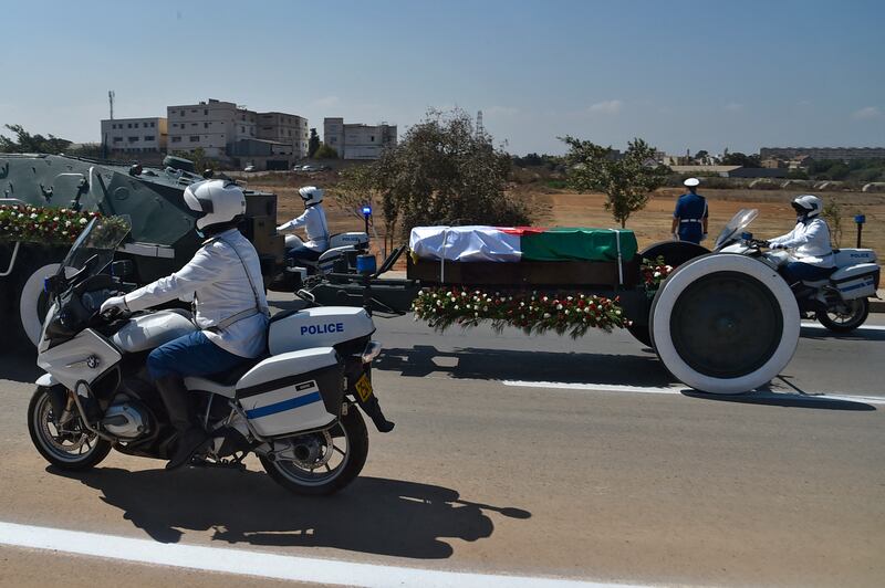 Algerian security forces accompany the coffin of former president Abdelaziz Bouteflika to the El-Alia cemetery in the capital Algiers. AFP