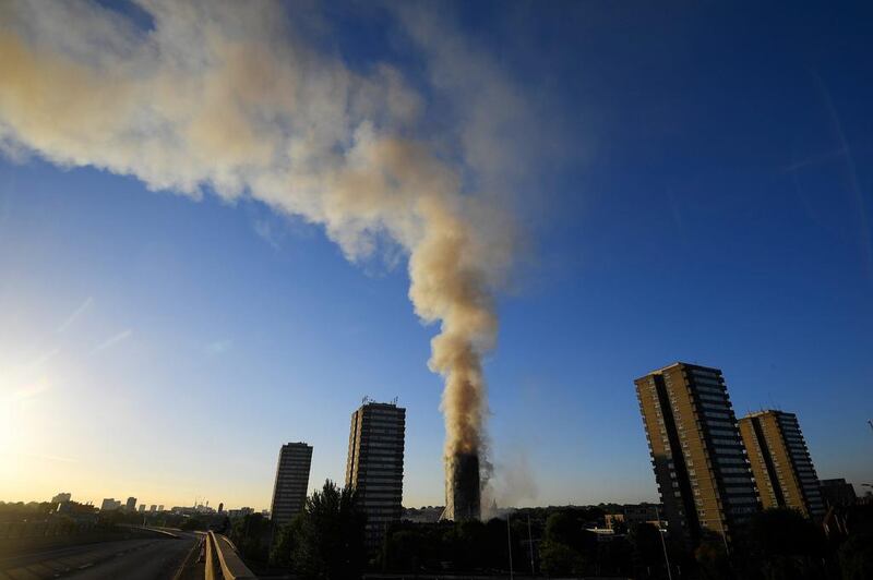The A40 road is seen closed as flames and smoke billow as firefighters deal with the fire. Toby Melville / Reuters