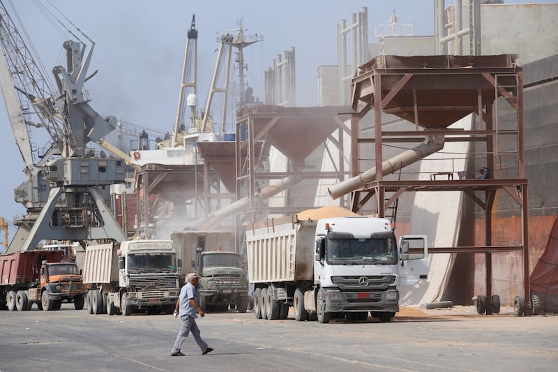 A man walks past a cargo ship unloading wheat at the Red Sea port of Hodeida, Yemen.  File photo / Reuters