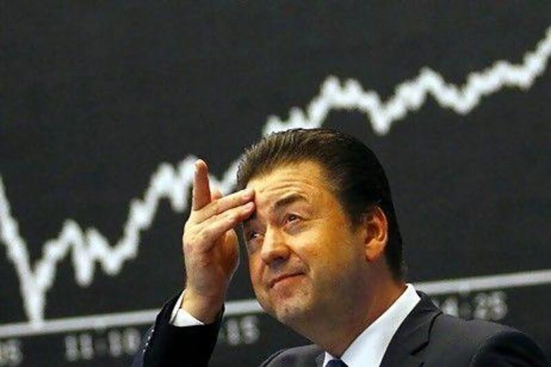 A share trader reacts as he watches the opening figures of the New York Stock Exchange yesterday.