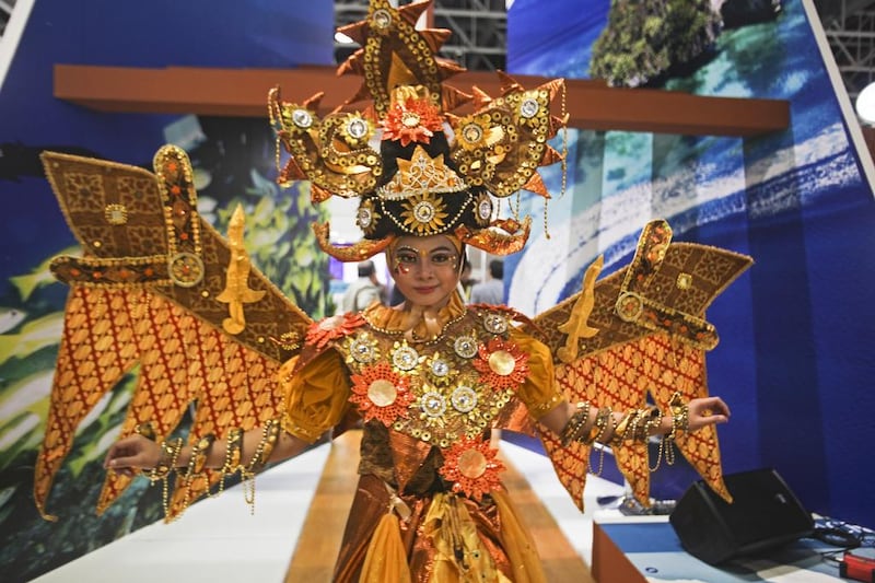 National dress was in abundance at the Arabian Travel Market, as national tourist boards dusted off the most extravagant costumes from the back of their cupboards. Ajend here is wearing an Indonesian carnival costume. Lee Hoagland / The National