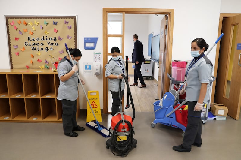 Staff cleaning the doors, classrooms and corridors at Brighton College Dubai.