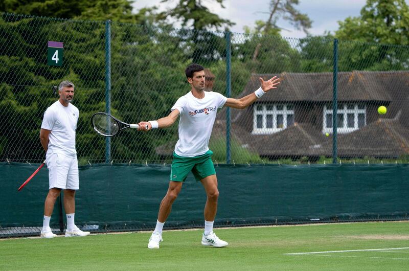 Serbia's Novak Djokovic, watched by coach Goran Ivanisevic (L) takes part in a practice session at The All England Tennis Club in Wimbledon, southwest London, on June 25, 2021, ahead of the start of the 2021 Wimbledon Championships tennis tournament. RESTRICTED TO EDITORIAL USE
 / AFP / POOL / POOL / POOL / AELTC/Thomas Lovelock / RESTRICTED TO EDITORIAL USE
