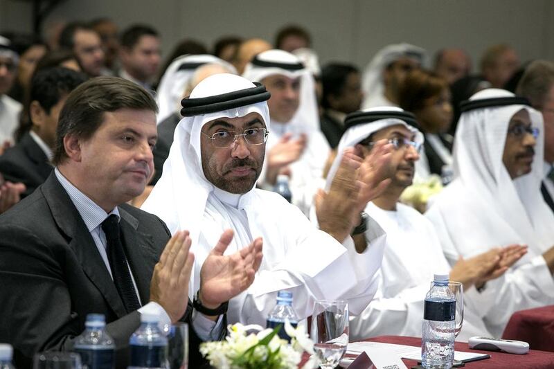 Carlo Calenda, the Italian vice minister of economic development, left, and Ahmed Ali Mohamed Al Sayegh, chairman of the Abu Dhabi Global Market, second left, applaud a keynote speech at the 6th Annual Global UAE Investment Forum. Silvia Razgova / The National