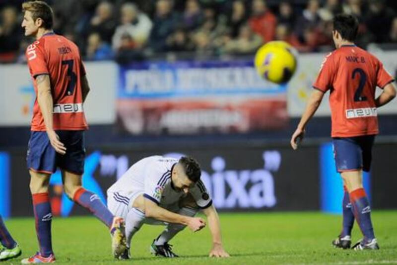 Real Madrid's Karim Benzema laments a wasted chance against Osasuna.