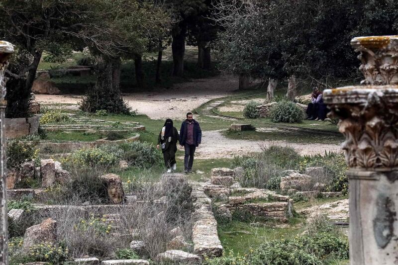 A couple walk through the remains of the Sanctuary of Apollo in the ruins of Libya's ancient eastern city of Cyrene. AFP