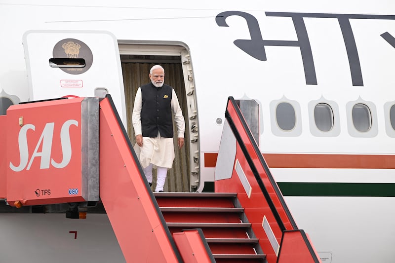 Mr Modi disembarks from his plane after landing. AFP