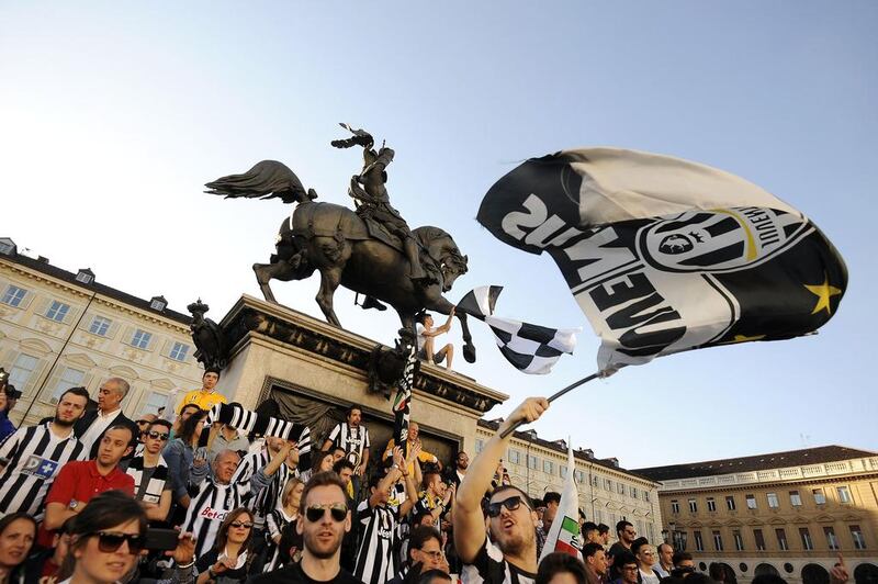 Juventus supporters gather and wave flags in central Piazza San Carlo square to celebrate their victory of the Serie A championship. Giorgio Perottino / Reuters / May 4, 2014