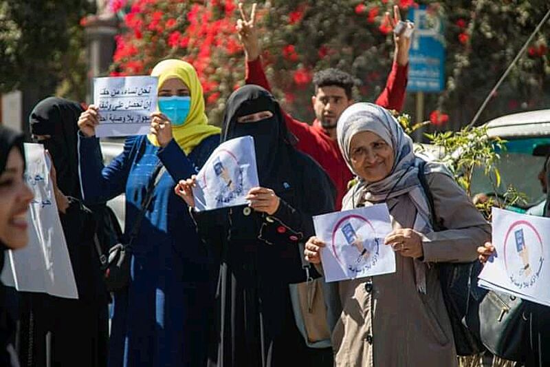 Activists demanding the abolition of guardianship on women's passports during a protest in front of the Passports and Immigration Building in early February 2022, in the city of Taiz, Southern Yemen.