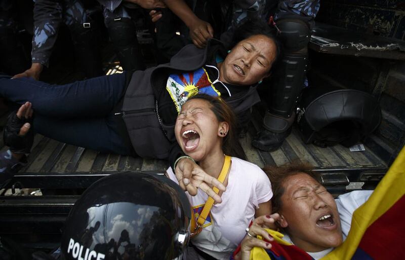 Nepalese police personnel detain Tibetan activists during their protest near the Chinese Embassy Consular office in Kathmandu. Navesh Chitrakar / Reuters