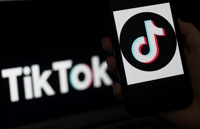 (FILES) In this file illustration photo taken on April 13, 2020 the social media application logo of TikTok is displayed on the screen of an iPhone in Arlington, Virginia  TikTok, the social media platform that is all the rage with the world's teens, could break away from its Chinese parent to evade a US ban, a top White House adviser said on July 16, 2020. "We haven't made final decisions (on the ban) but as has been reported in some places, I think TikTok is going to pull out of the holding company which is China-run and operate as independent company," White House economic advisor Larry Kudlow told reporters.
 / AFP / Olivier DOULIERY
