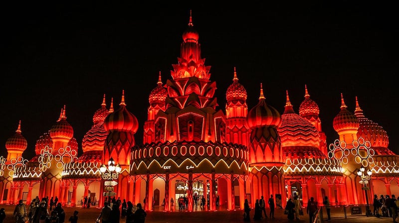 Global Village in Dubai is bathed in red light ahead of the Hope probe's arrival in Martian orbit on Tuesday evening. Pictures by AP / EPA / Dubai Media Office