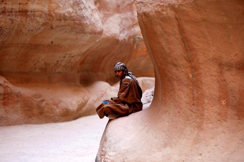 A Bedouin young man sits in the Siq in the ancient city of Petra, south of Amman, Jordan. Reuters