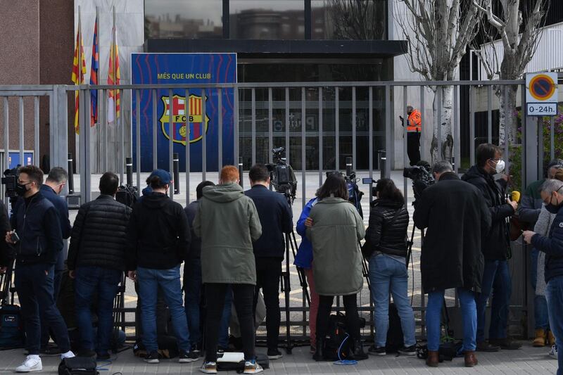 Journalists stand in front of the gate of Barcelona club office. AFP