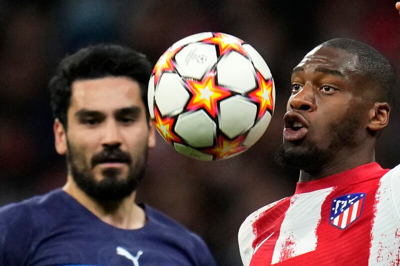 Manchester City's Ilkay Gundogan watches as Atletico's Geoffrey Kondogbia controls the ball. AP