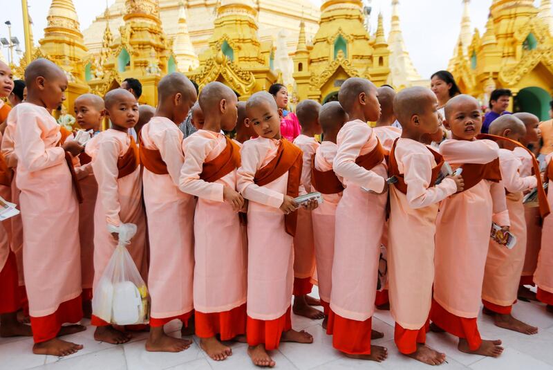 Young Buddhists arrive to pray at the Shwedagon pagoda to mark the Myanmar New Year Day in Yangon. Lynn Bo Bo / EPA