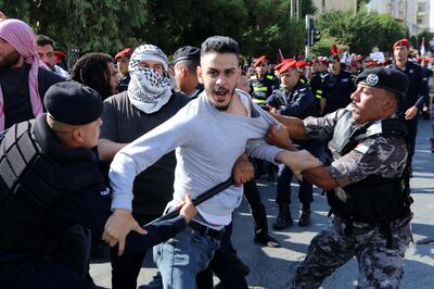 Members of the security forces try to stop protesters during a pro-Palestinian rally in Amman, Jordan, on Wednesday. EPA