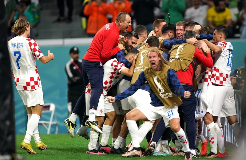 Croatia's Bruno Petkovic is mobbed by teammates after scoring. PA