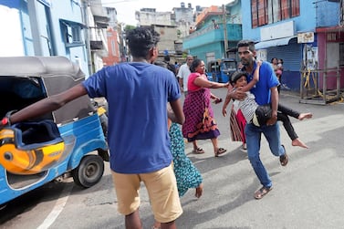 People who live near the church that was attacked yesterday, leave their houses as the military try to defuse a suspected van before it exploded, in Colombo. Reuters