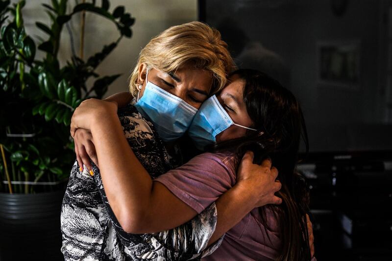 Coronavirus survivor Azareth Amaya Gamez, right, embraces her mother Glenda Yaneth Amaya Gamez inside their home in Miami Gardens, Florida, USA. AFP