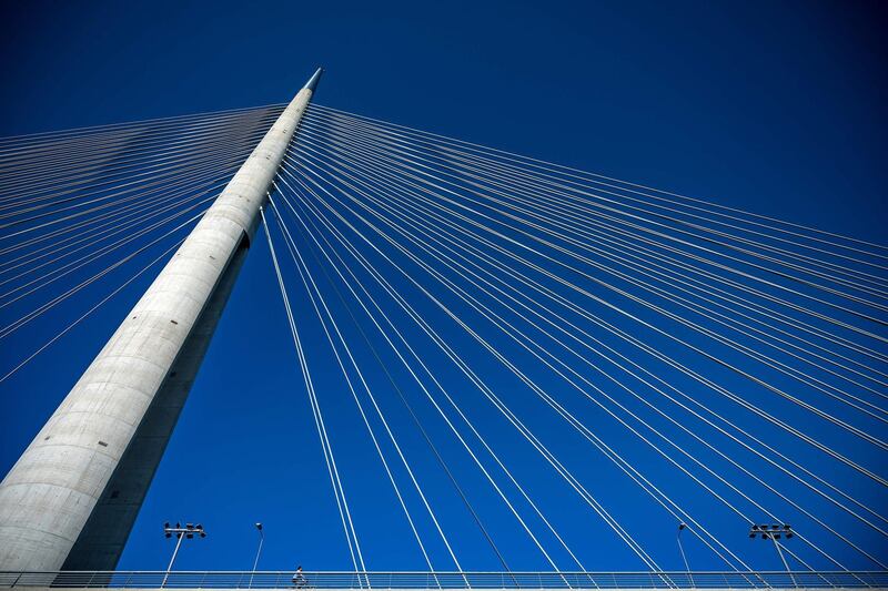 A man rides a bicycle over the Ada bridge in Belgrade, Serbia. AFP