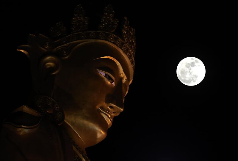 A multiple exposure image shows the so-called 'Supermoon' near the Buddha statue in Yangon, Myanmar. Nyein Chan Naing / EPA