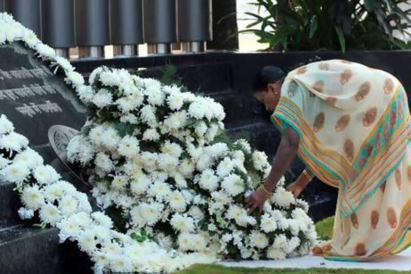 Tarabai Omble, wife of Mumbai police assistant sub-inspector Tukaram Omble, who died while trying to arrest Ajmal Kasab, lays a wreath at a memorial for police who lost their lives in the 2008 terror attacks.