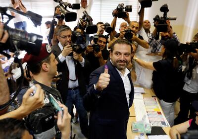 Lebanese prime minister and candidate for the parliamentary election Saad al-Hariri shows his ink-stained finger after casting his vote during the parliamentary election in Beirut, Lebanon, May 6, 2018. REUTERS/Jamal Saidi
