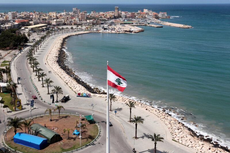 A national flag flutters at a nearly deserted corniche, during a countrywide lockdown in the southern city of Tyre, Lebanon. Reuters