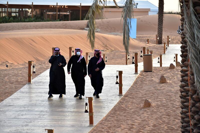 Men enjoy the views from a walkway at the "Riyadh Oasis." AFP