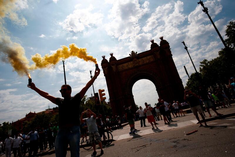 A protester holds flares during a strike by taxi drivers in Barcelona.  AFP / Pau Barrena