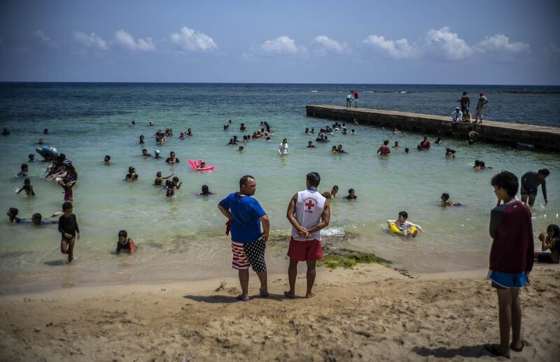 People spend the afternoon on Playa del Salado beach in Caimito, Artemisa province, Cuba. With government restrictions easing and a heatwave sweeping the island, Cubans are packing the beaches without face masks. The coronavirus infection rates in the country remain low. AP Photo