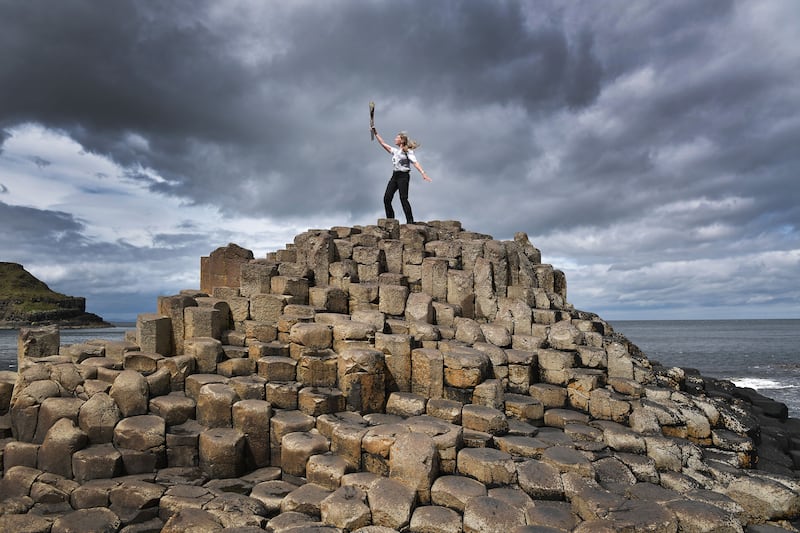 Lucy Walton holds the baton at the top of the Giants Causeway in Portrush, Northern Ireland. Getty Images