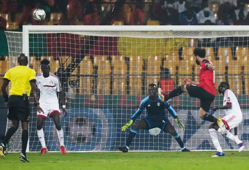 Sudan goalkeeper Ali Abou Achrine watches on as Egypt's Mohamed Salah shoots at goal. AP Photo