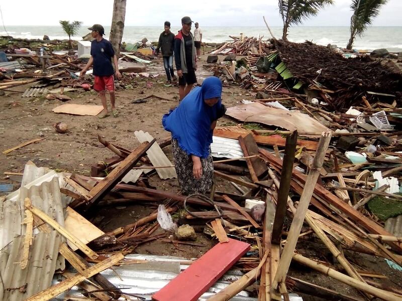 Residents inspect the damage to their homes on Carita beach. AFP