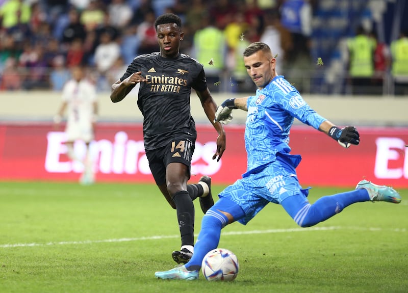 Lyon goalkeeper Anthony Lopes clears the ball under pressure from Eddie Nketiah. Reuters