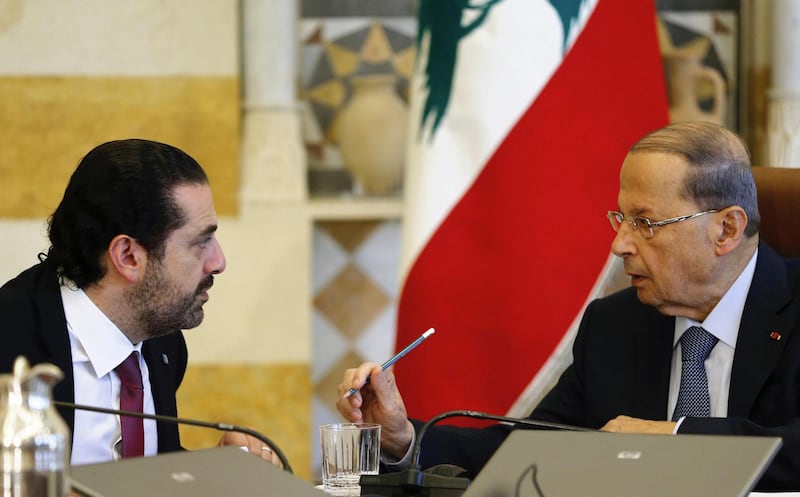 Lebanon's President Michel Aoun talks to Prime Minister Saad al-Hariri during the cabinet meeting in Baabda near Beirut, Lebanon December 5, 2017. REUTERS/Mohamed Azakir