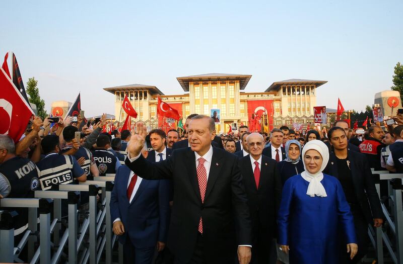 epa06090512 A handout photo made available by the Presidential Press Office shows Turkish President Recep Tayyip Erdogan (R) greeting his supporters during a ceremony to mark the first anniversary of the failed Coup attempt on 15 July, in front of the new monument of martyrs at Presidential Palace in Ankara, Turkey early 16 July 2017. The 15 July 2017 events marked the first anniversary of the failed coup attempt which led to some 50 thousand workers being dismissed, some eight thousand people arrested, and scores of news outlets shut down by the government. Turkish President Recep Tayyip Erdogan blamed US-based Turkish cleric Fetullah Gulen and his movement for masterminding the failed coup and Turkey remains under a state of emergency as a result.  EPA/PRESIDENTIAL PRESS OFFICE HANDOUT  HANDOUT EDITORIAL USE ONLY/NO SALES