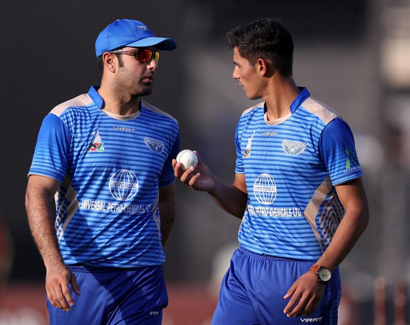 Sharjah, United Arab Emirates - October 18, 2018: Captain of the Balkh Legends Mohammad Nabi (L) speaks to his bowler Samiullah during the game between Kandahar Knights and Balkh Legends in the Afghanistan Premier League. Thursday, October 18th, 2018 at Sharjah Cricket Stadium, Sharjah. Chris Whiteoak / The National