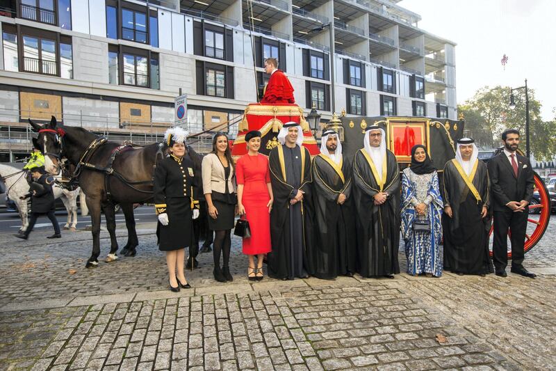 His Excellency Mansoor Abdulhoul following his visit with Her Majesty The Queen at Buckingham Pallace for the presentation of diplomatic credentials. Seen here with his wife in red with black hat, Victoria Devin and the deputy Marshal of the Diplomatic Core with feathers in hat. Outside the Lanesborough Hotel in central London where the reception HE Mansoor Abdulhoul's in D'honneur took place.