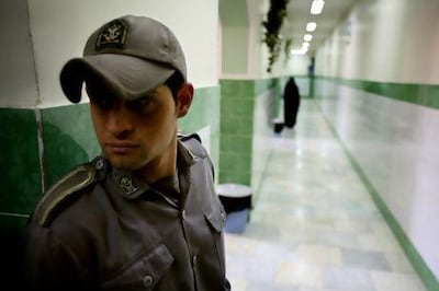 A guard stands along a corridor in Tehran's Evin prison, where detainees are rarely out of site. Reuters