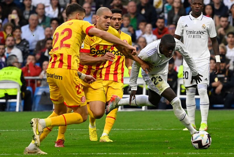 Girona's Spanish midfielder Oriol Romeu vies with Real Madrid's French defender Ferland Mendy. AFP