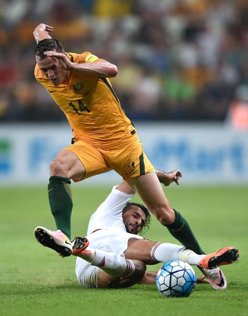 UAE’s Ali Mabkhout and Brad Smith of Australia battle for the ball. Tom Dulat / Getty Images