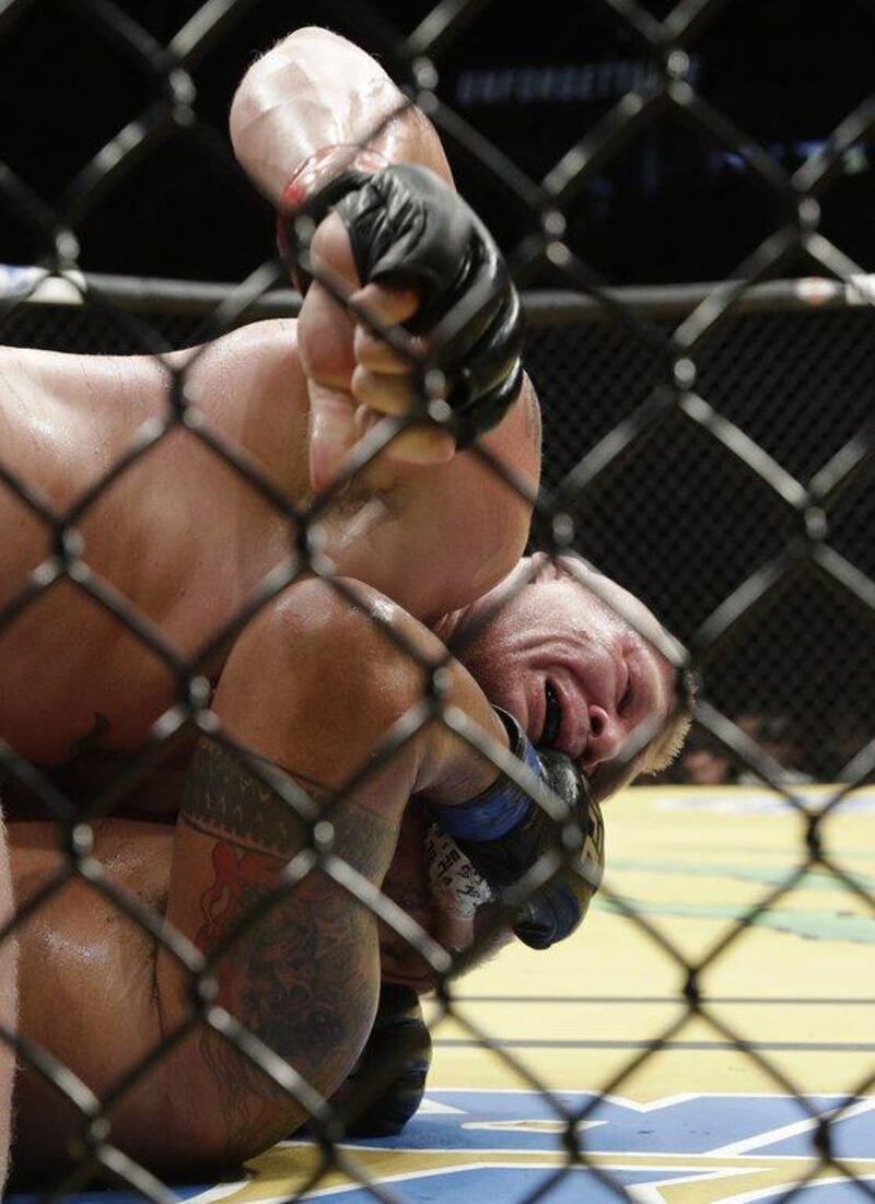 Brock Lesnar, top, fights Mark Hunt during their heavyweight bout at UFC 200, Saturday, July 9, 2016, in Las Vegas. John Locher / AP Photo