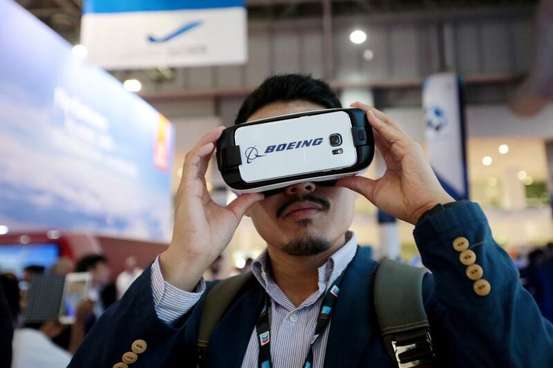 A visitor tries out a virtual reality tour of Boeing aircrafts during the Dubai Airshow. Christopher Pike / The National