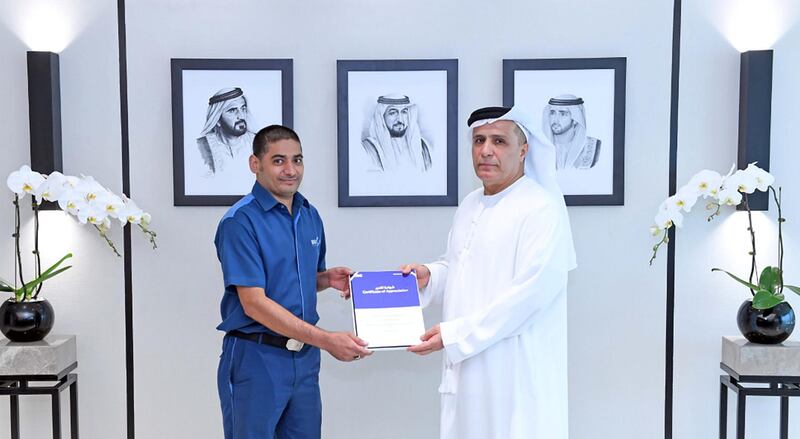 Taher Ali Maqbool, a cleaner from Pakistan, is handed a token of appreciation by Mattar Al Tayer, director general of Dubai's Roads and Transport Authority. Courtesy: RTA 