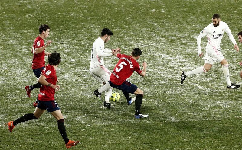 Osasuna defender David Garcia battles for the ball with Real Madrid's Marco Asensio. EPA
