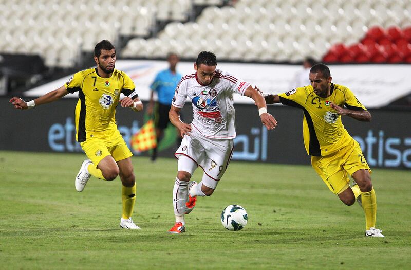 ABU DHABI , UNITED ARAB EMIRATES Ð Oct 15 : Ricardo De Oliveira ( no 99 in white ) of Al Jazira and Essa Ali ( no 7 in yellow left ) and Yaser Salem ( no 29 in yellow right ) in action during the Etisalat Cup round 3 football match between Al Wasl vs Al Jazira at Mohammad Bin Zayed stadium in Abu Dhabi.  ( Pawan Singh / The National ) For Sports. Story by Amit