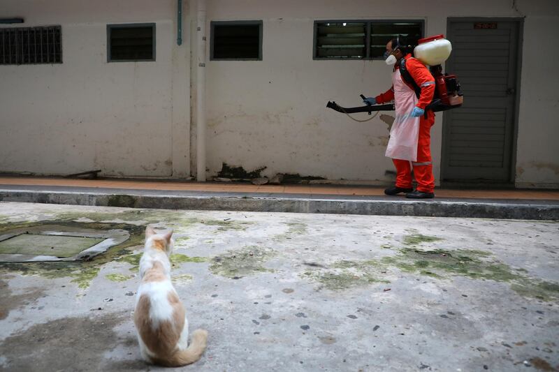 A worker sprays disinfectant at an apartment in Kuala Lumpur, Malaysia. Reuters