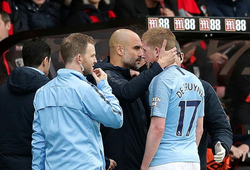 Guardiola consoles injured player Kevin De Bruyne as he leaves the pitch. PA via AP